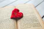 red heart on a old opened book